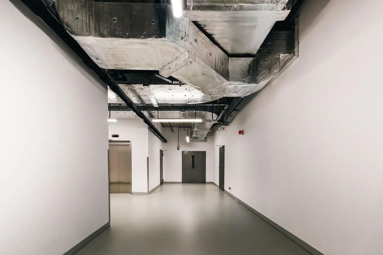 Industrial hallway where ductwork carries conditioned air