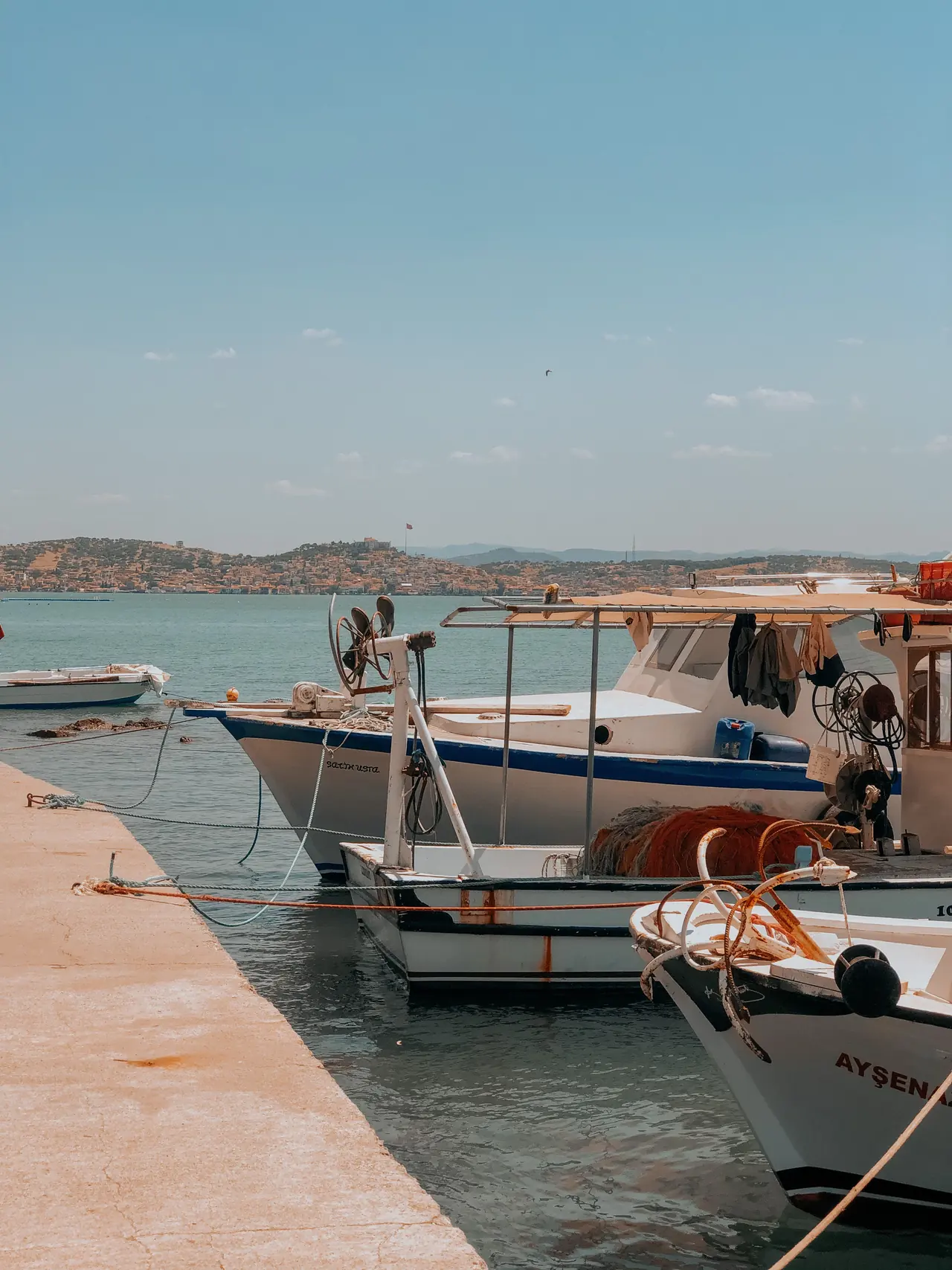 Working boats tied alongside a concrete dock