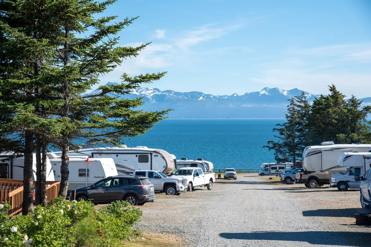 Motorhomes and travel trailers parked in an open lot