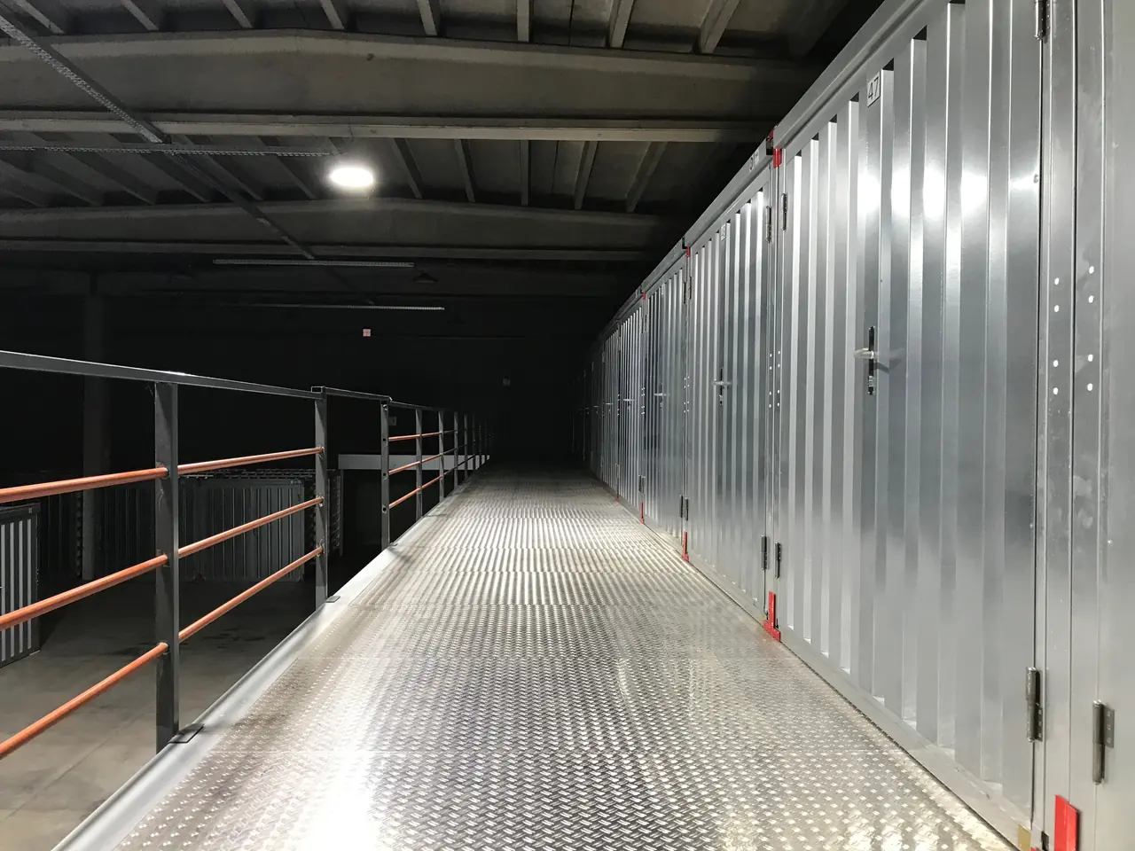 Metal storage doors along an indoor corridor